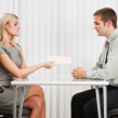 Termination -- Woman giving a man a pink slip