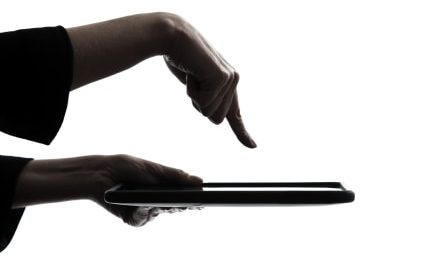 Social Media Use Discriminatory -- woman hand computer computing typing digital tablet silhouette
