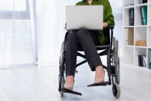 Disability in the Workplace woman in wheelchair working-laptop